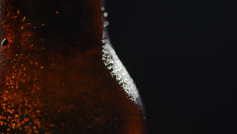 Close-Up-Of-Condensation-Droplets-On-Revolving-Bottle-Of-Cold-Beer-Or-Soft-Drink-2